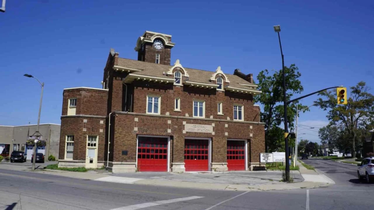 Historic brick central fire station with red garage doors