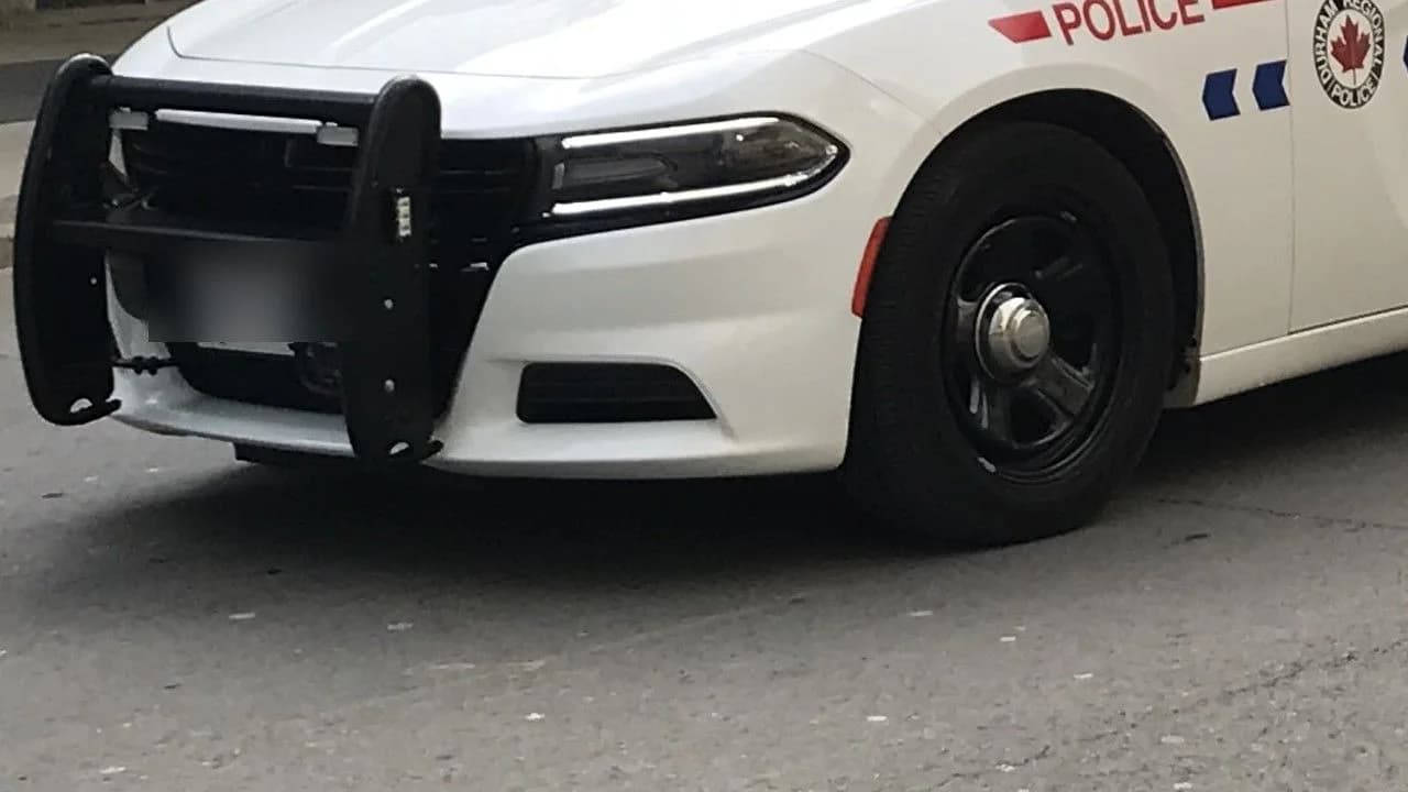 Front of a Durham Regional Police marked cruiser with push bar, POLICE lettering and service badge; no people shown.