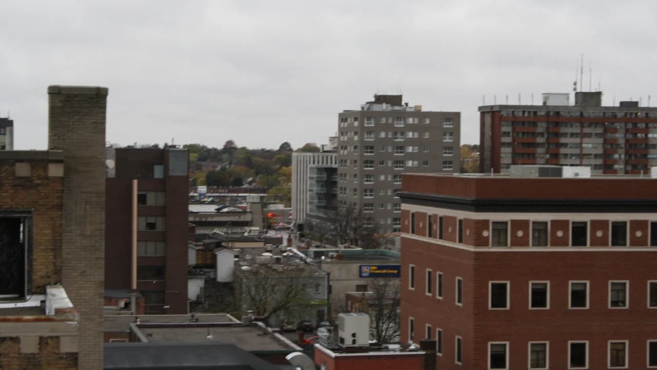 Downtown Oshawa rooftops and buildings under an overcast sky; no people visible.