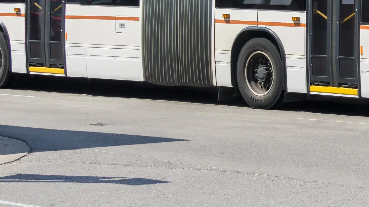 A Durham Region Transit articulated bus, side detail with accordion section; no people visible.