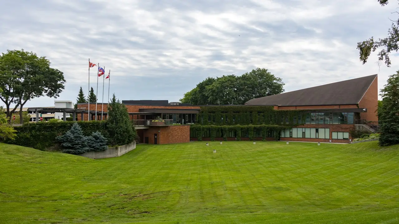 The Whitby Town Hall building on Rossland Road in Whitby, Ontario, photographed on a cloudy day